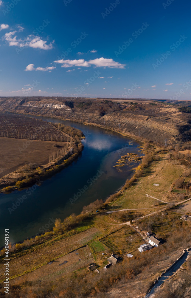 Naklejka premium Aerial view of Lyadova christian orthodox monastery in Lyadova village, Travel and vacation, recreation. Autumn sunny day. Dniester river. Vinnytsa region, Vertical photo Ukraine