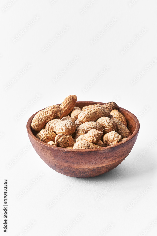 Bowl of peanuts with shell isolated on a white background Bowl of peanuts with shell isolated on a white background
