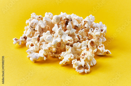  Bunch of salty popcorns on a yellow background