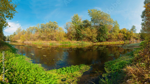 Panoramic view of the Vorskla River in summer. Coastal vegetation. Pure river water photo