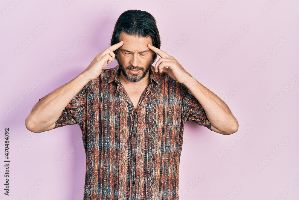 Middle age caucasian man wearing casual clothes with hand on head for pain in head because stress. suffering migraine. Middle age caucasian man wearing casual clothes with hand on head for pain in head because stress. suffering migraine.