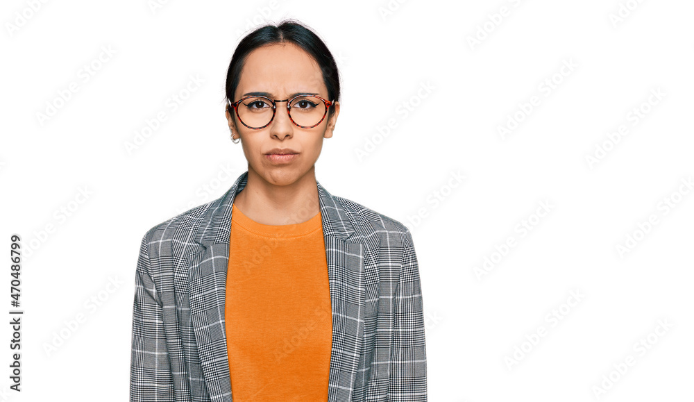 Young hispanic girl wearing business jacket and glasses depressed and worry for distress, crying angry and afraid. sad expression.
