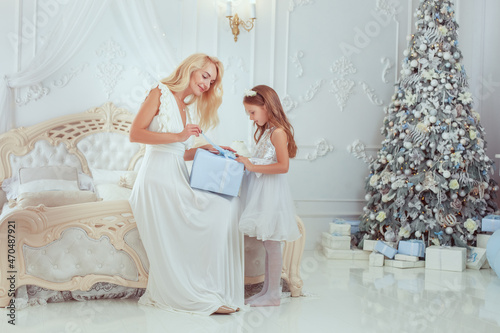 Girl gives a New Year's gift to her mother.