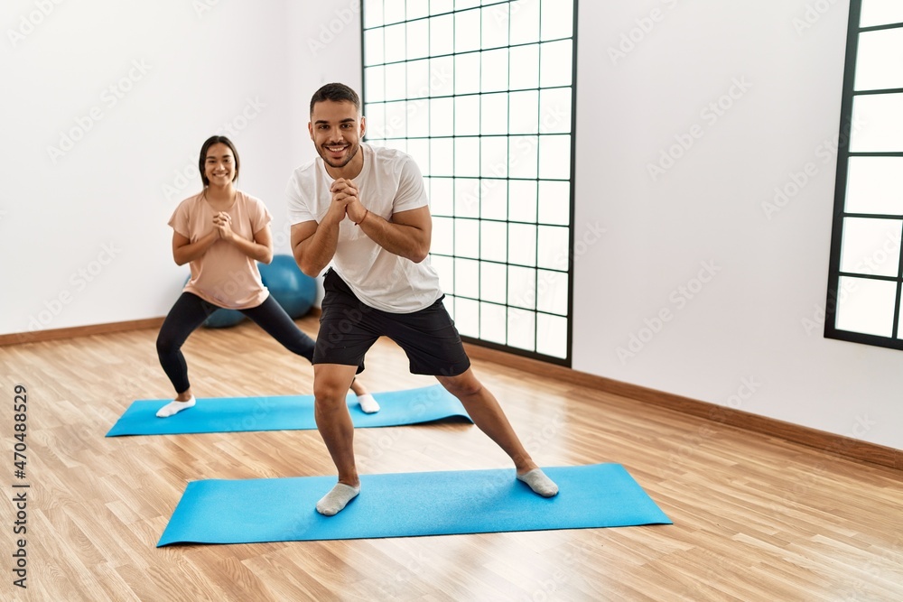 Latin man and woman couple smiling confident stretching at sport center Latin man and woman couple smiling confident stretching at sport center