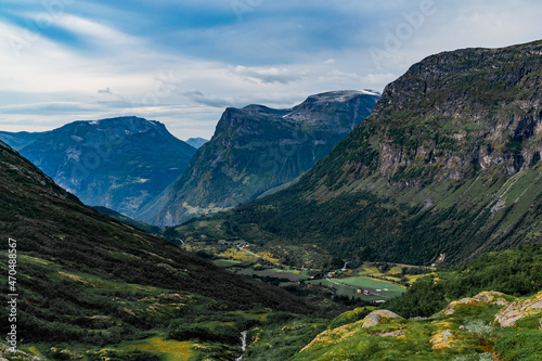 View from the road on a the valley between beautiful Norwegian mountains against  dramatic cloudy sky