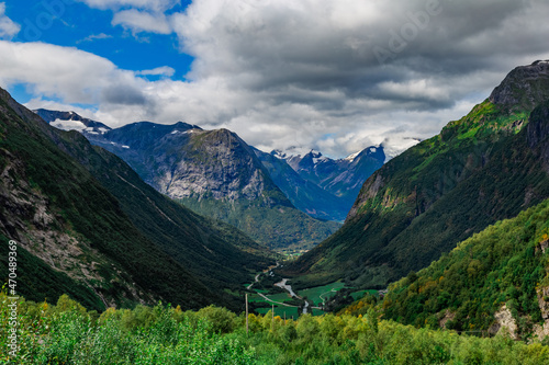 Scenic view from the road on a the valley between beautiful Norwegian mountains against dramatic cloudy sky