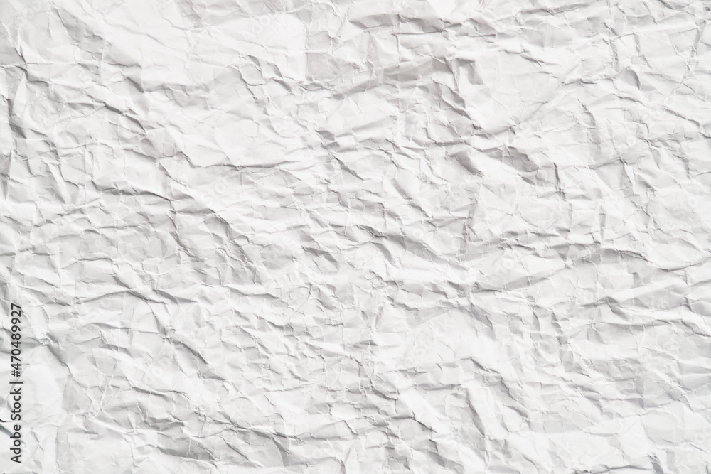 White crumpled paper texture with wrinkles. Damaged and torn sheet