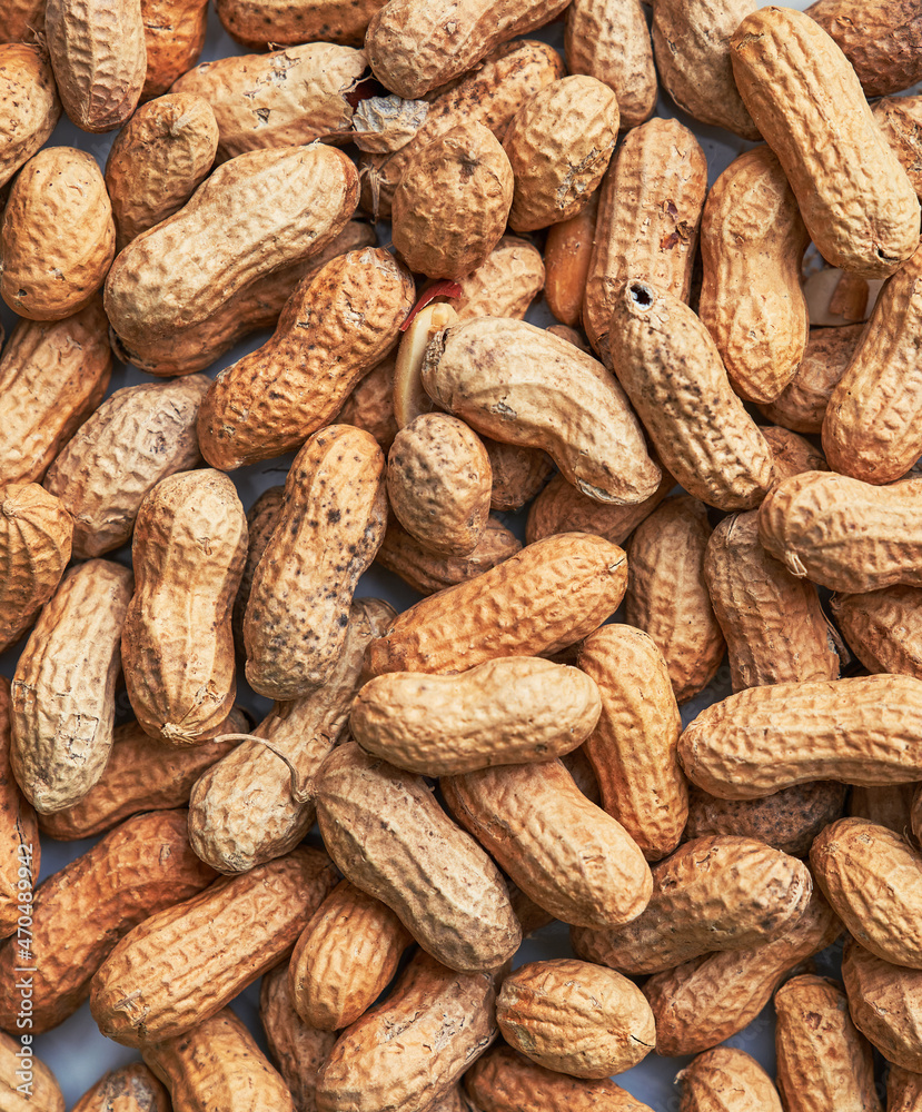 Healthy roasted unpeeled peanuts. Brown nuts texture Healthy roasted unpeeled peanuts. Brown nuts texture