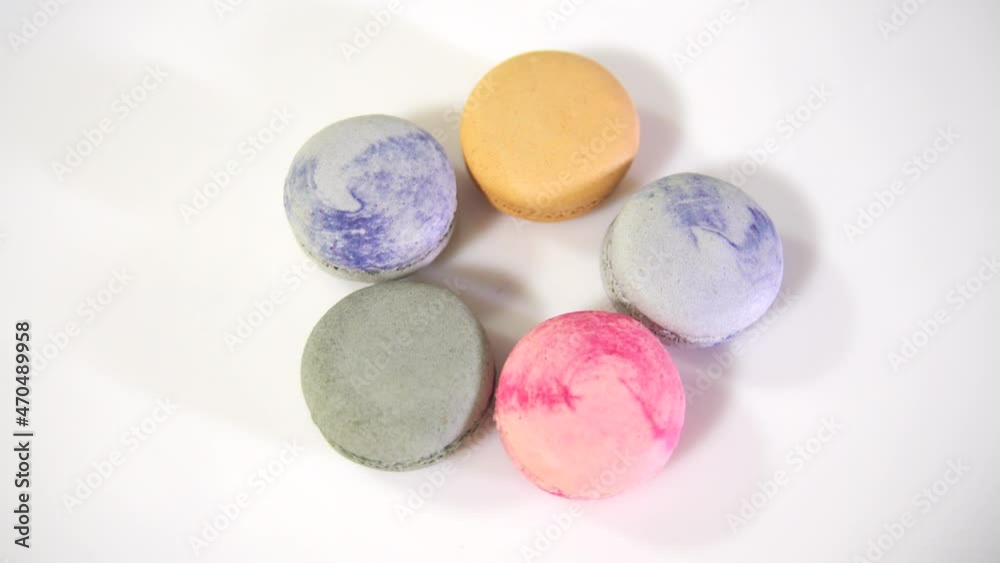 multicolored macarons, rotate on its axis on a white background. High quality 4k video multicolored macarons, rotate on its axis on a white background. High quality 4k video