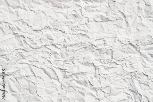 White crumpled paper texture with wrinkles. Damaged and torn sheet