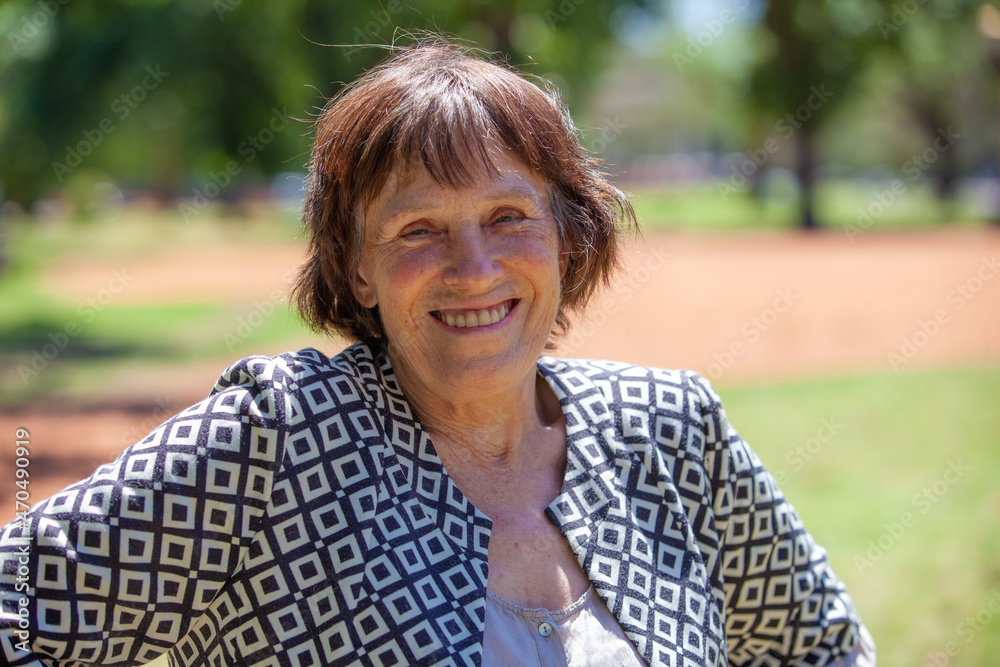 Elderly happy woman on nature. Portrait