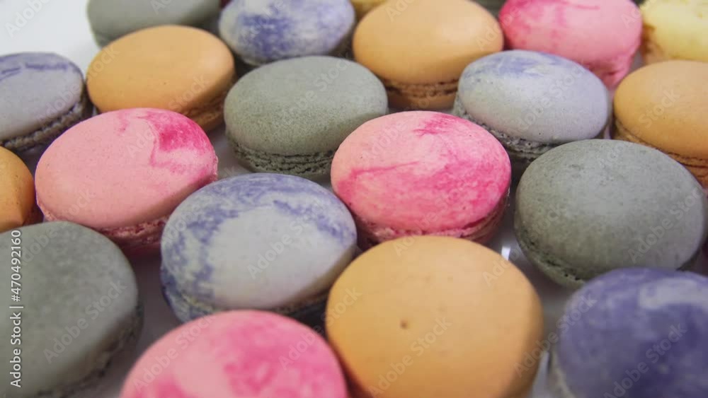 multicolored macarons, rotate on its axis on a white background. High quality 4k video multicolored macarons, rotate on its axis on a white background. High quality 4k video