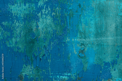 Wooden backdrop with copy space. Blue colored peeling off old painted surface with a many scratches and scrapes.
