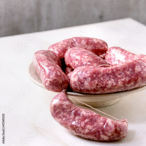 Bunch of raw uncooked italian sausages salsiccia photo