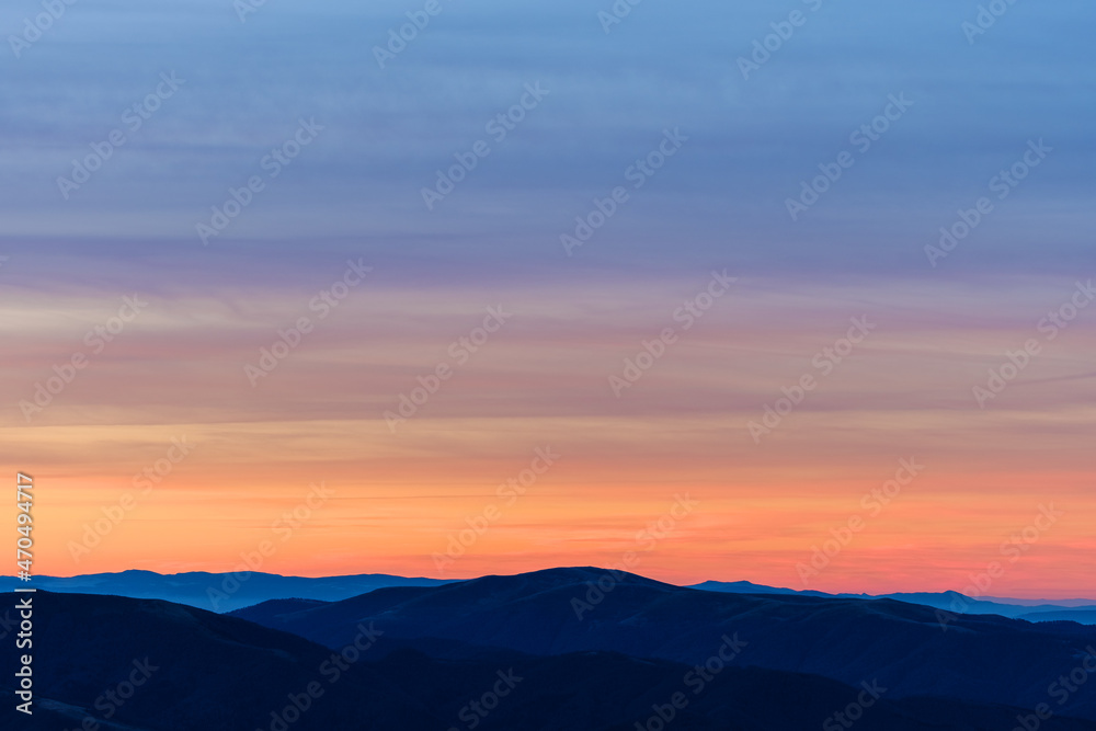 Beautiful orange sky over mountain range at sunset