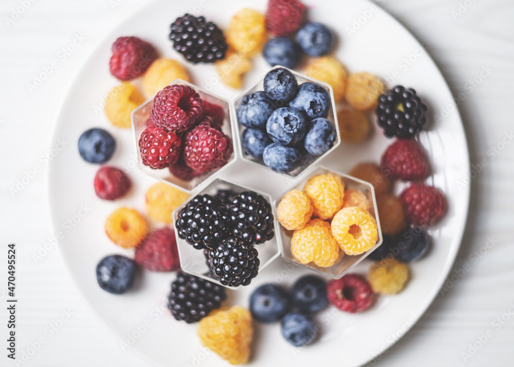 Fresh berries in honeycomb like hexagonal jars Fresh berries in honeycomb like hexagonal jars