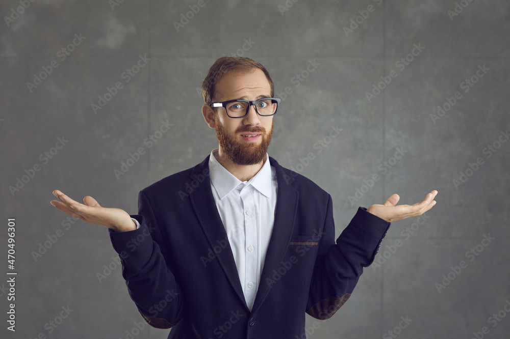Irritated adult caucasian businessman with displeased face expression in formal suit showing so what or dont know gesture studio headshot. Confused man shrugging up looking at camera portrait - obrazy, fototapety, plakaty 