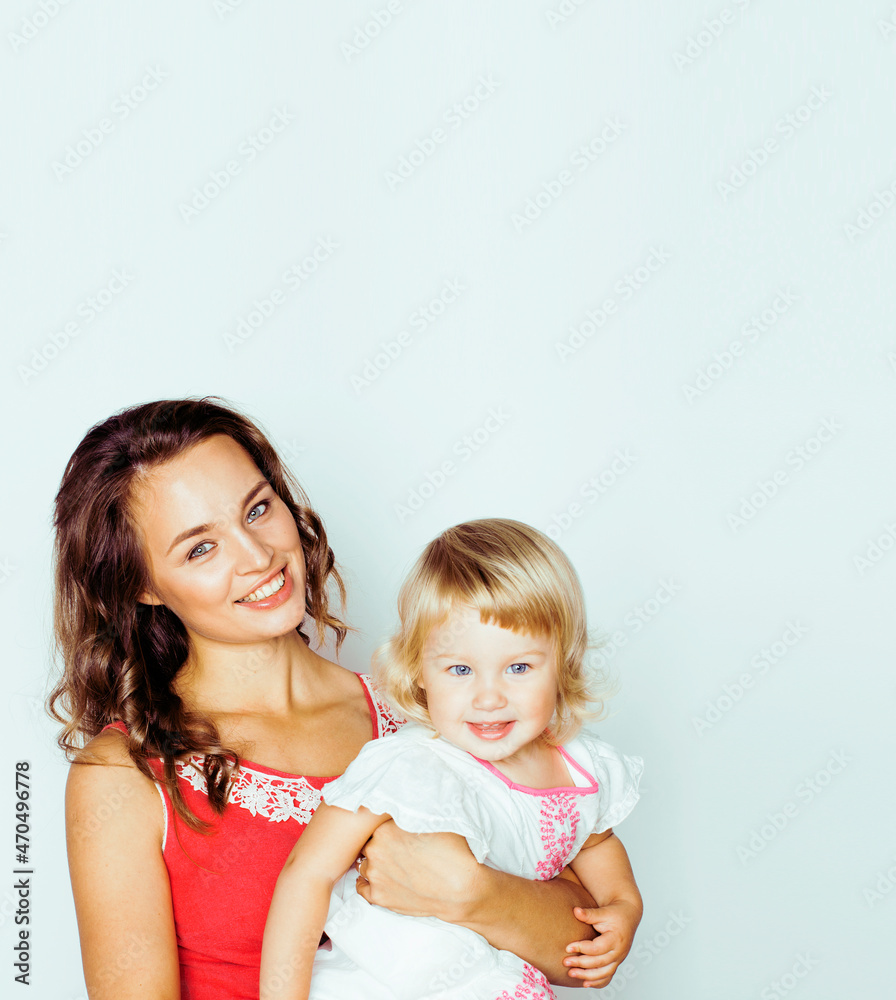 young modern smiling blond mother with little cute daughter on white background, happy girls family inside isolated adorable young modern smiling blond mother with little cute daughter on white background, happy girls family inside isolated adorable