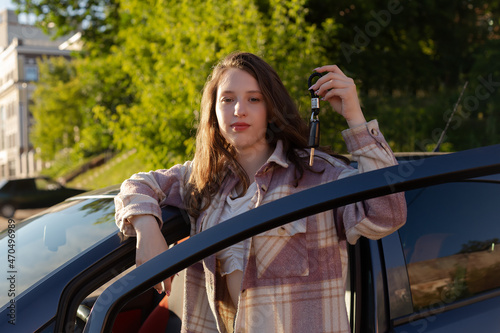 A girl with a car key in her hand. Rent, sale and purchase of a car © Alexander