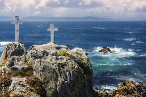 Crosses along the coast in memory of the brave fishermen who perished in the attempt to find the most beautiful and tastiest of barnacles, cape Roncudo, coast of death in Galicia, Spain