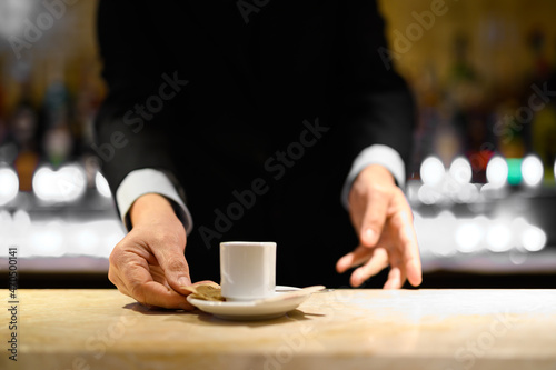 Closeup of a barman serving you a coffee