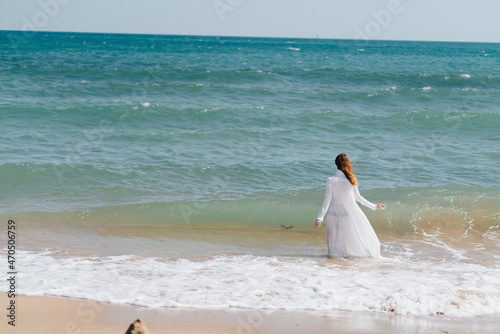 Woman in white dress freedom walk on ocean island