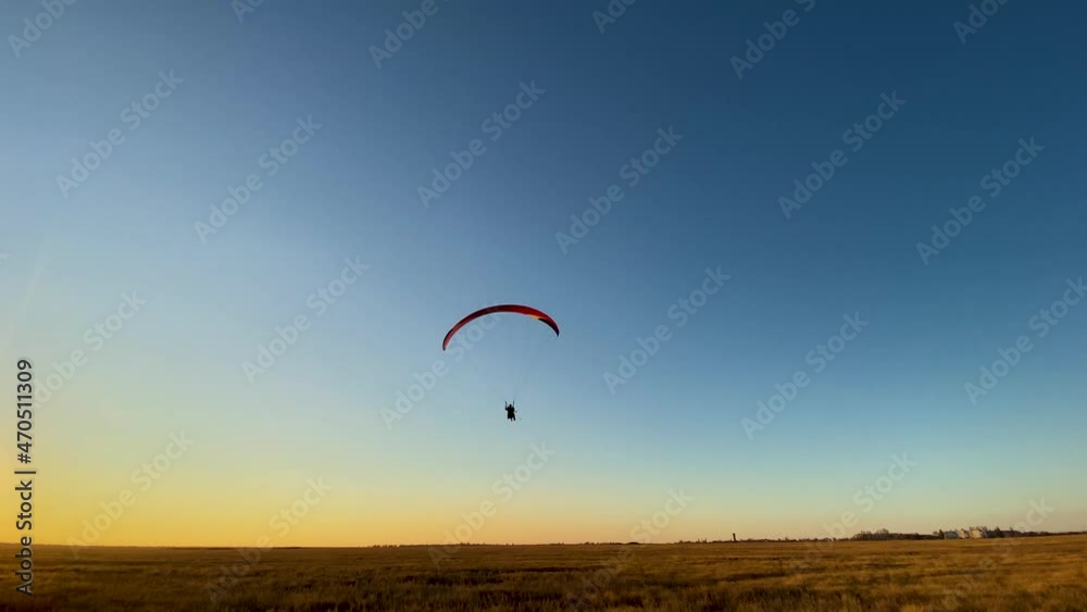 Paraglider takes off against the background of the blue evening sky Paraglider takes off against the background of the blue evening sky