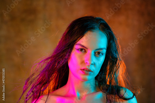 Portrait shot of a pretty young woman in RGB colors.