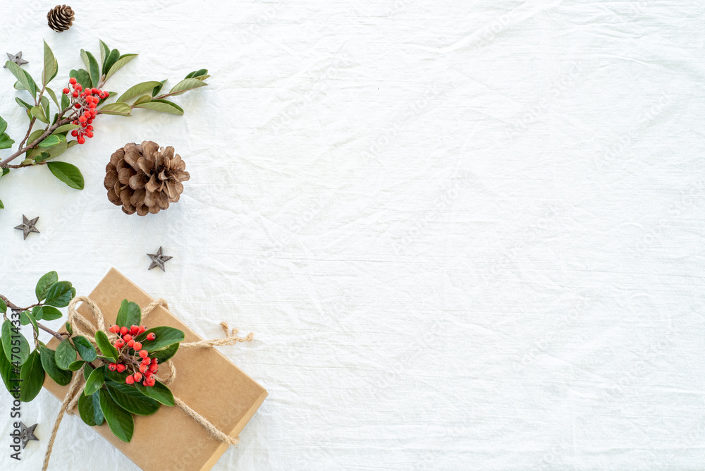 custom made wallpaper toronto digitalChristmas decorations composition on white linen background with gift box, pine branches, pine cone, wooden stars and red berry branches. Greeting card mockup.Banner. Copy space, top view, flat lay