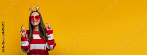 Stampa su tela Banner photo of cute happy and charming young woman in a Christmas reindeer antl