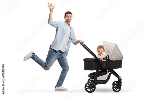 Full length profile shot of a happy father running with a baby in a stroller