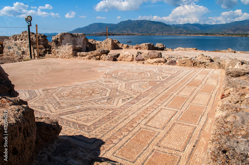 Excavations in Nora, Sardinia - old stone mosaic on the ground with remnants of walls photo