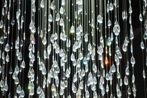 Vászonkép Crystal stones dangle and glisten on black background