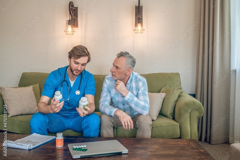Qualified doctor explaining to patient how to choose dietary supplements Qualified doctor explaining to patient how to choose dietary supplements