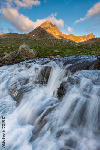 Mountain river in the Italian Alps with fiery peaks in the background  Stelvio National Park  Lombardy  Italy