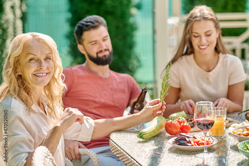 A family sitting at the table and dining