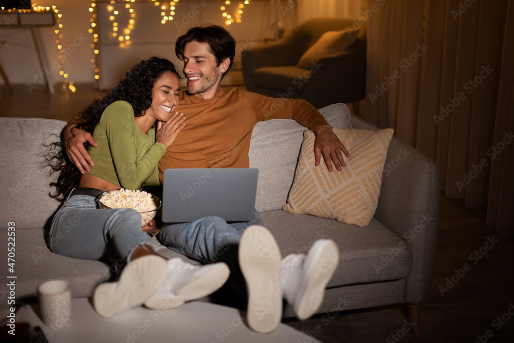 Couple Laughing Watching Comedy Movie On Laptop At Home Couple Laughing Watching Comedy Movie On Laptop At Home