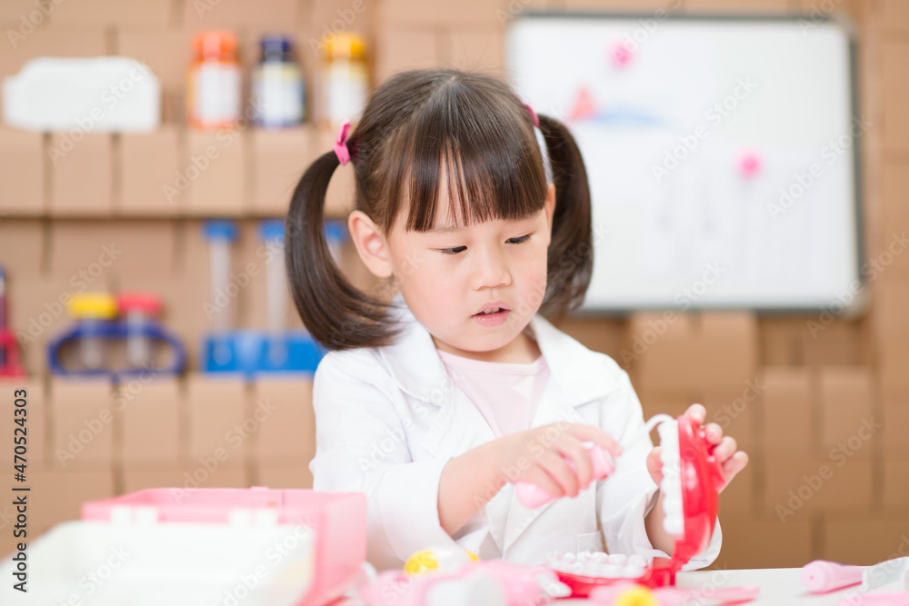 young girl pretend play dentist role at home young girl pretend play dentist role at home