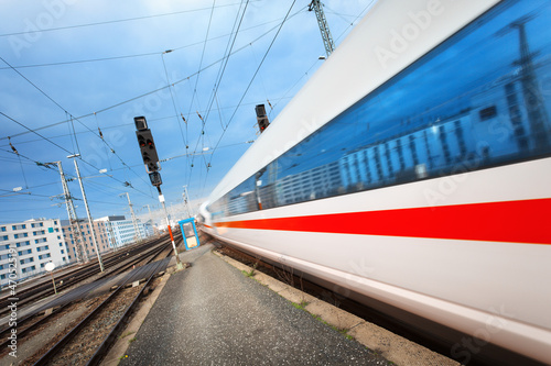 Modern high speed passenger train on railroad track in motion