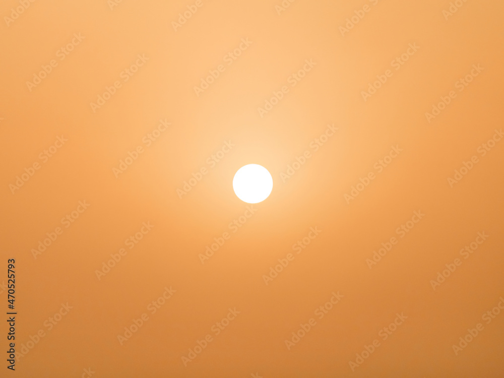 View to the sun during the middle of day in desert. Arabian orange sky. View to the sun during the middle of day in desert. Arabian orange sky.