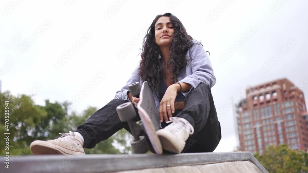 Mixed race beautiful fit hispanic black millennial woman in New York city. skateboarder girl hipster at skatepark. Urban modern lifestyle, fashion in NYC, multi-ethnic race American.