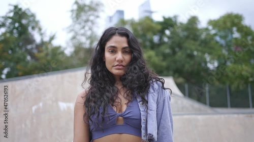Young multi-ethnic hispanic millennial female on New York city. skateboarder girl hipster at skatepark. Urban modern student lifestyle, hipster fashion in NYC, healthy lifestyle, mixed race American.