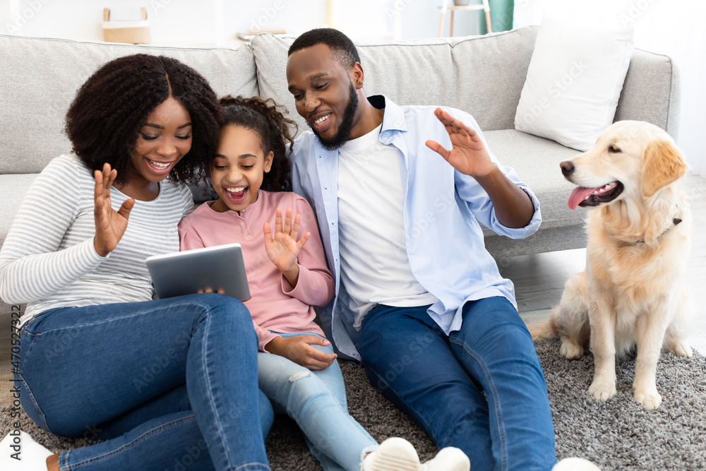 Black family having video chat using digital tablet waving hands Black family having video chat using digital tablet waving hands