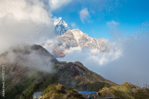 Mountain landscape. Mount Machapuchare (Fishtail) and guest houses on the Mardi Himal trek. Nepal, Himalayas