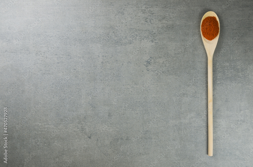 Paprika spice in wooden spoon Paprika spice in wooden spoon