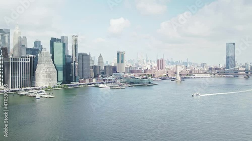 Ferry on Hudson east river. Aerial Manhattan view downtown New York city.  Urban life, modern city in America. office buildings, apartments in Manhattan. Drone NYC.
