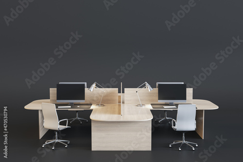 Creative coworking office interior with wooden furniture  computer monitors and empty mock up place on black background. 3D Rendering.