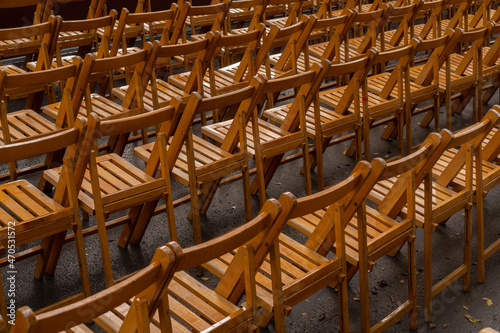 Set of empty folding chairs lined up before an event. Celebration, ceremony or event concept.