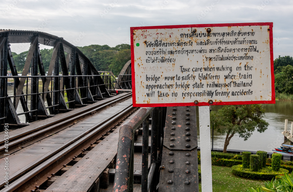Warning sign in Thai and English at bridge over the River Kwai in Kanchanaburi Thailand