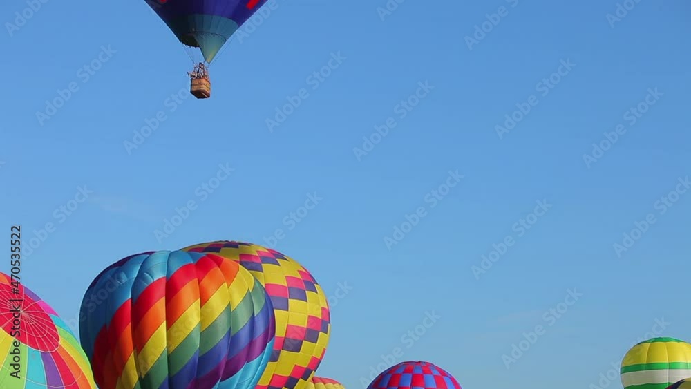 Multiple hot air balloons at an air show